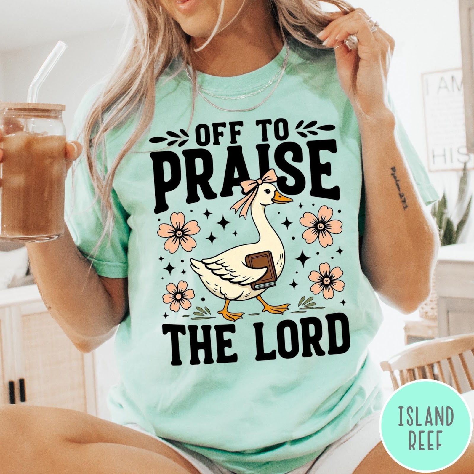 Comfort Colors tee in Island Reef featuring screen print style graphic of a goose carrying a book