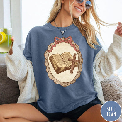 Comfort Colors tee in Blue Jean featuring vintage style graphic of an open Bible and wooden cross