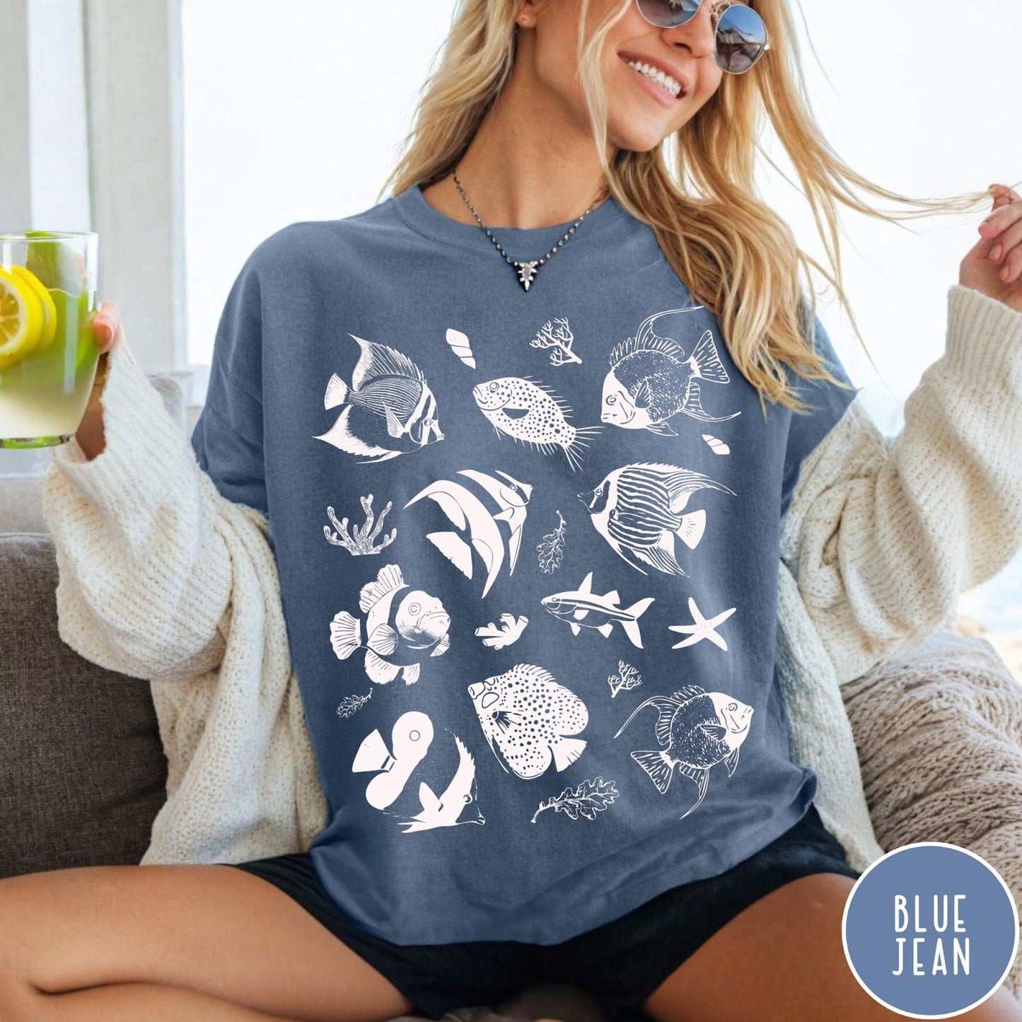 Comfort Colors tee in Blue Jean featuring coastal style graphic with various tropical fish and ocean life illustrations