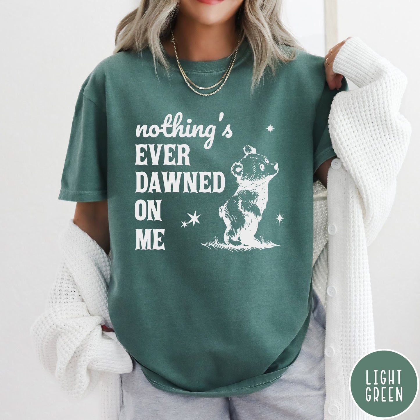 Comfort Colors tee in Light Green featuring illustrated style graphic of a small bear looking up at stars