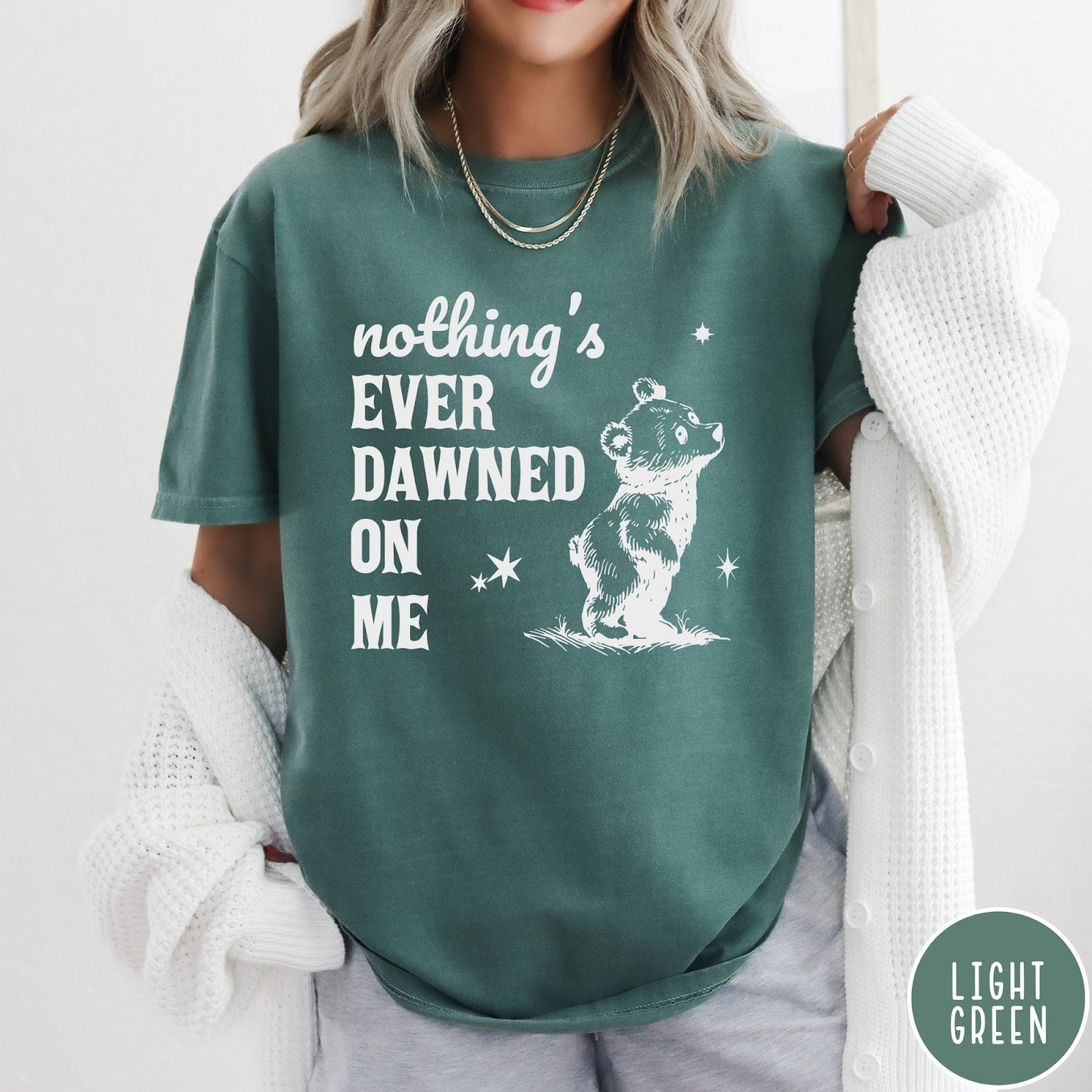 Comfort Colors tee in Light Green featuring illustrated style graphic of a small bear looking up at stars