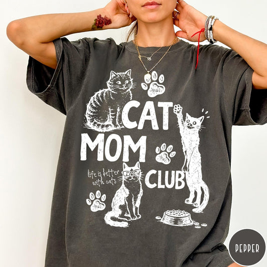 Comfort Colors tee in Pepper featuring vintage style graphic with cats, paw prints, and cat mom club text