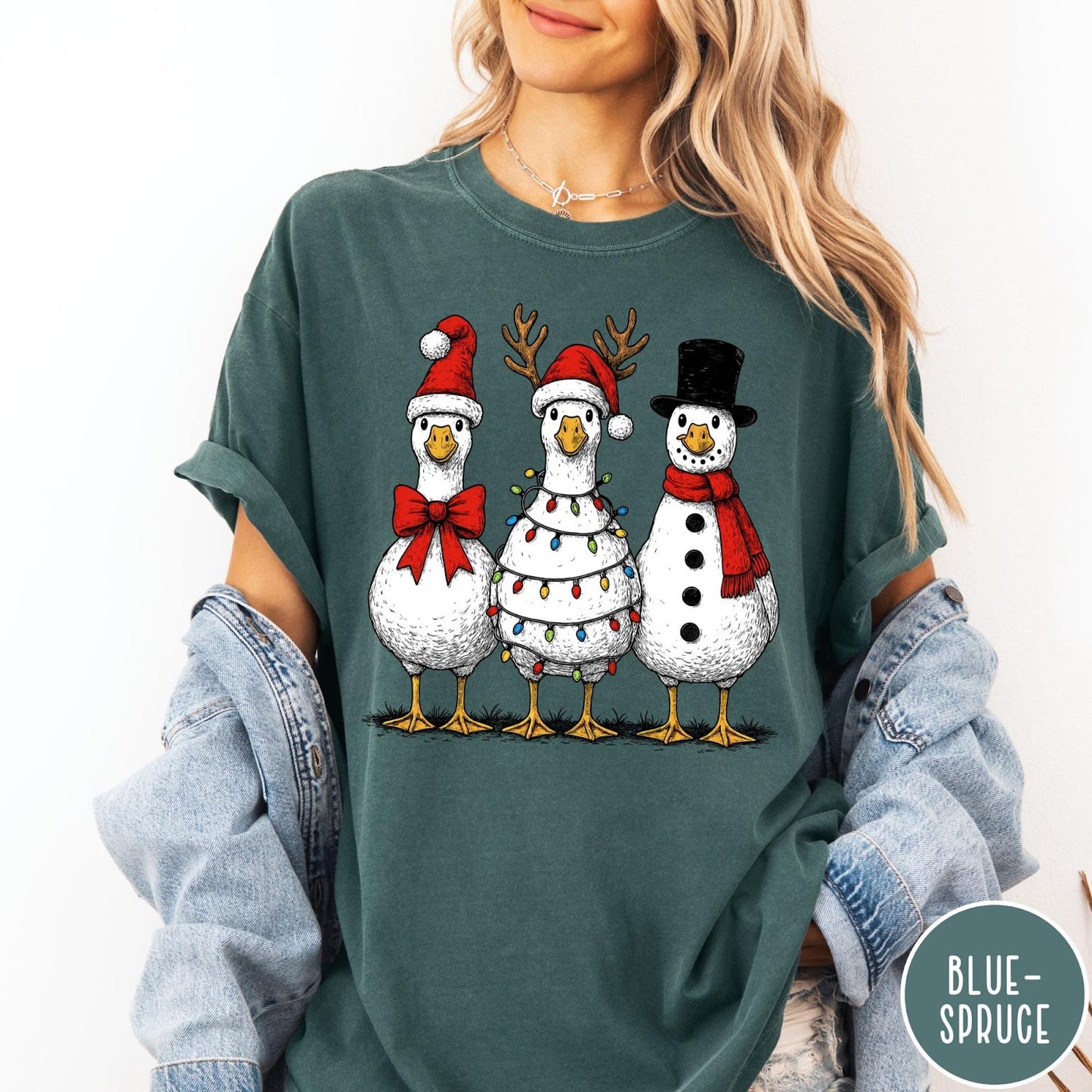 Comfort Colors tee in Blue Spruce featuring festive holiday graphic of three geese dressed as Santa and snowman