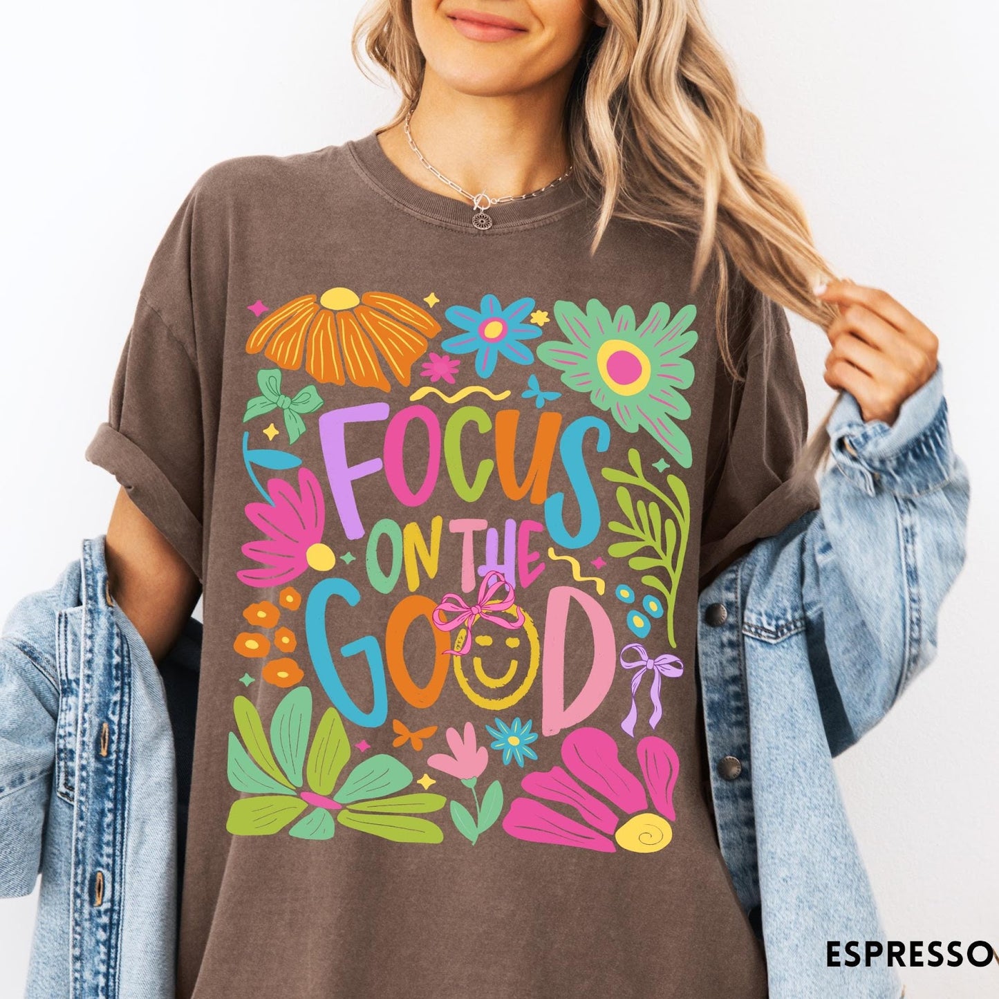 Comfort Colors tee in Espresso featuring positivity typography and floral collage graphic with a smiley face.