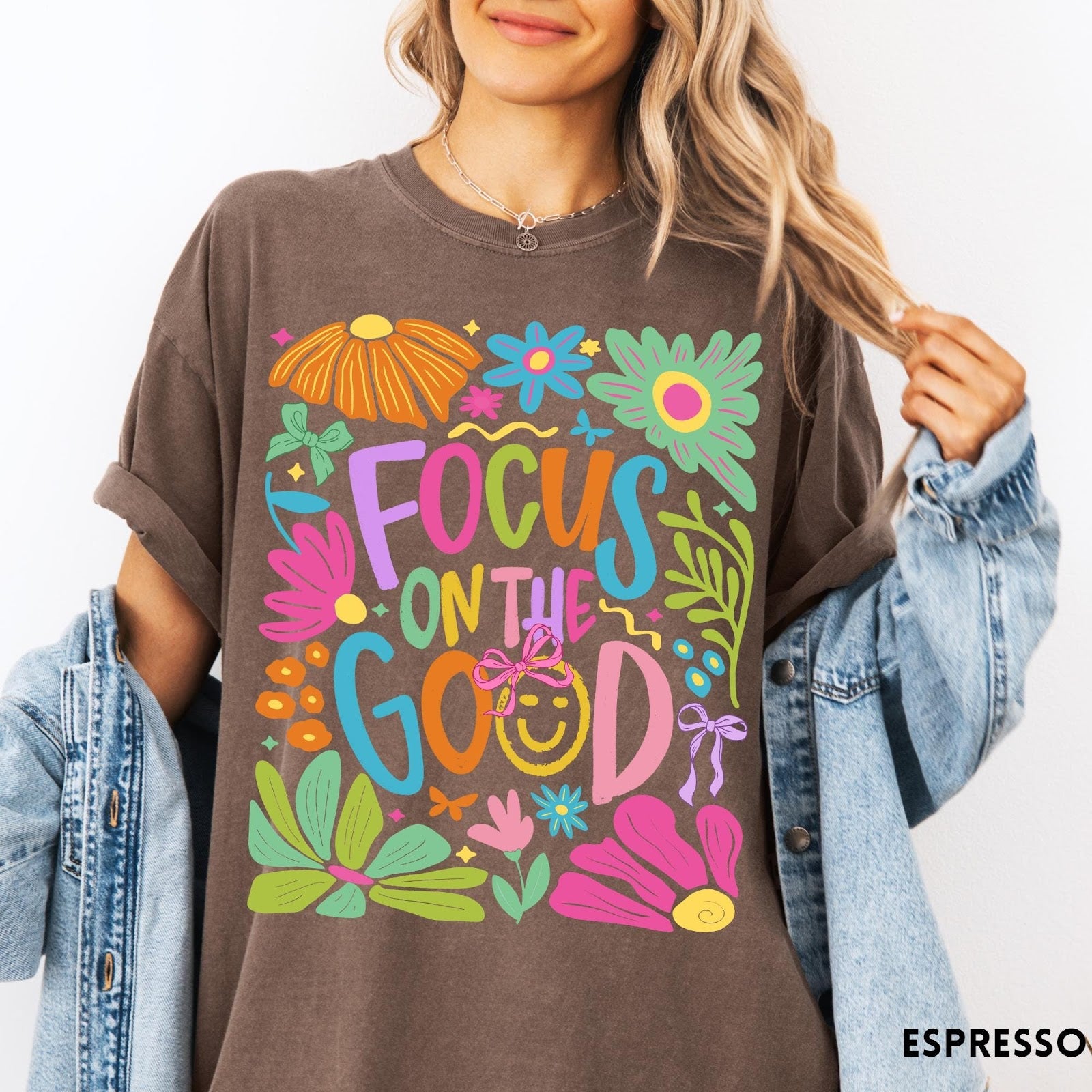Comfort Colors tee in Espresso featuring positivity typography and floral collage graphic with a smiley face.