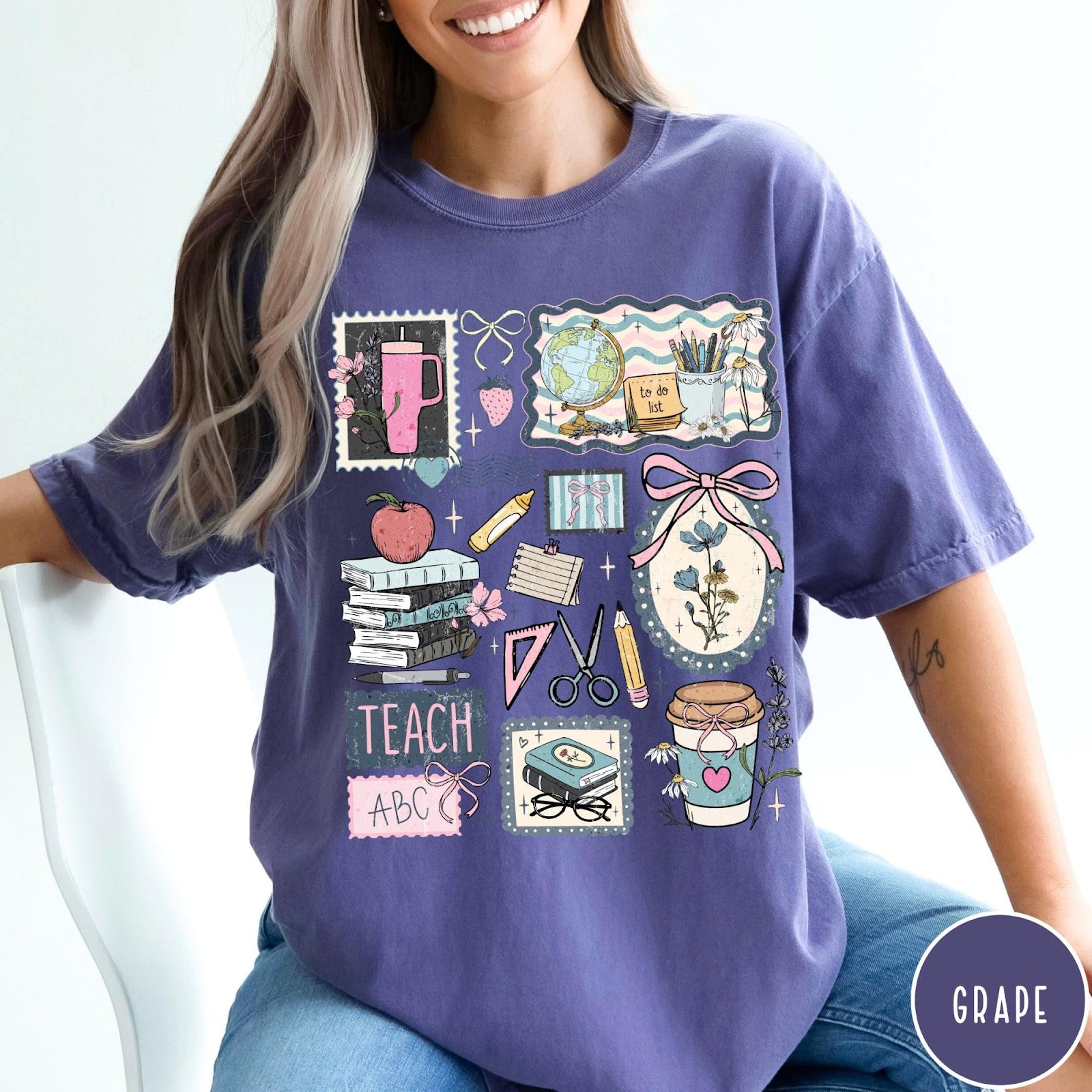 Comfort Colors tee in Grape featuring collage style graphic with school supplies, books, and teacher life elements