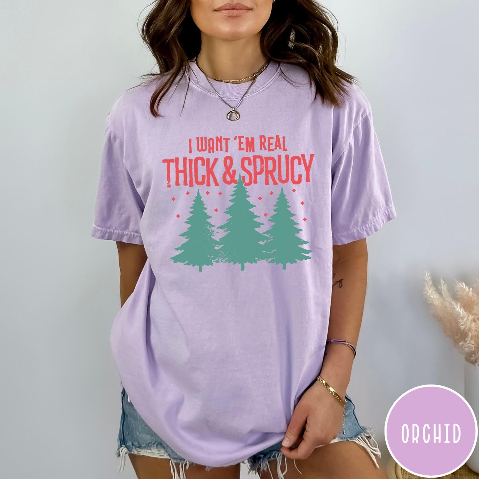 Comfort Colors tee in Orchid featuring Christmas tree design with text I Want Em Real Thick and Sprucy