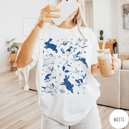 Comfort Colors tee in White featuring celestial design style with jumping bunnies and planets graphic print