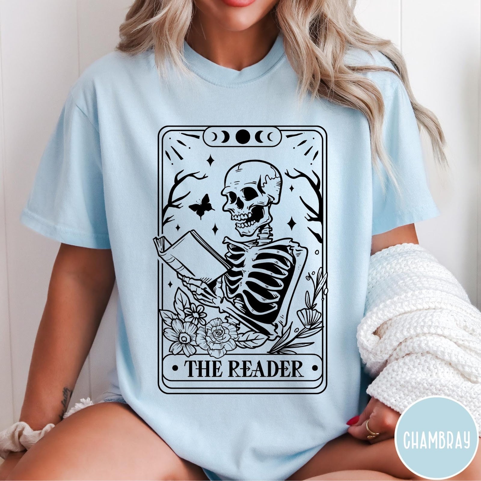 Comfort Colors tee in Chambray featuring tarot card style graphic of a skeleton reading a book