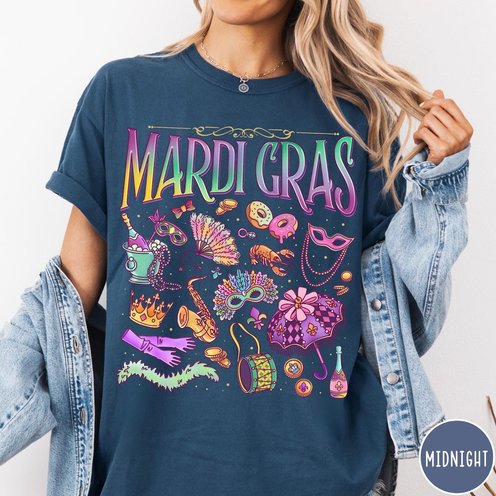Comfort Colors tee in Midnight featuring vintage style Mardi Gras icons including a saxophone, mask, and umbrella.