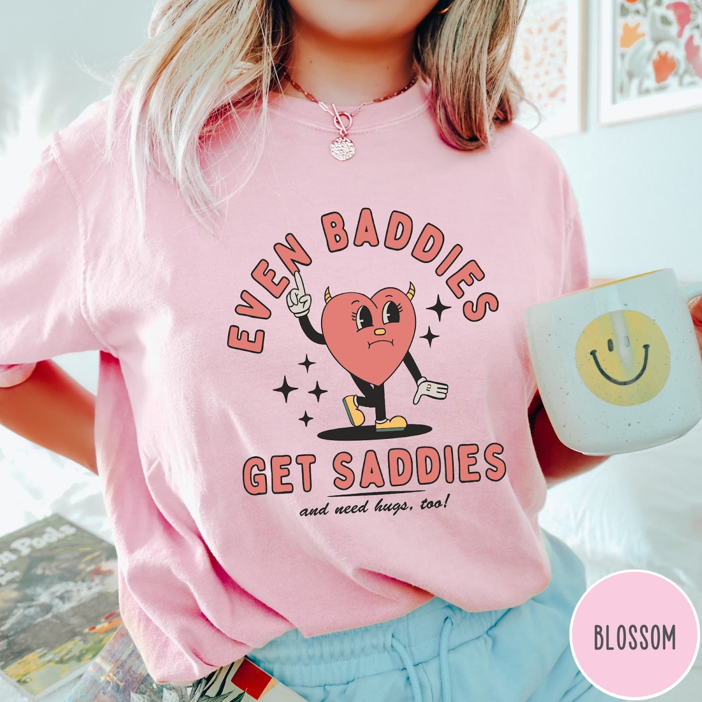 Comfort Colors tee in Blossom featuring retro style graphic of a sad heart character with devil horns
