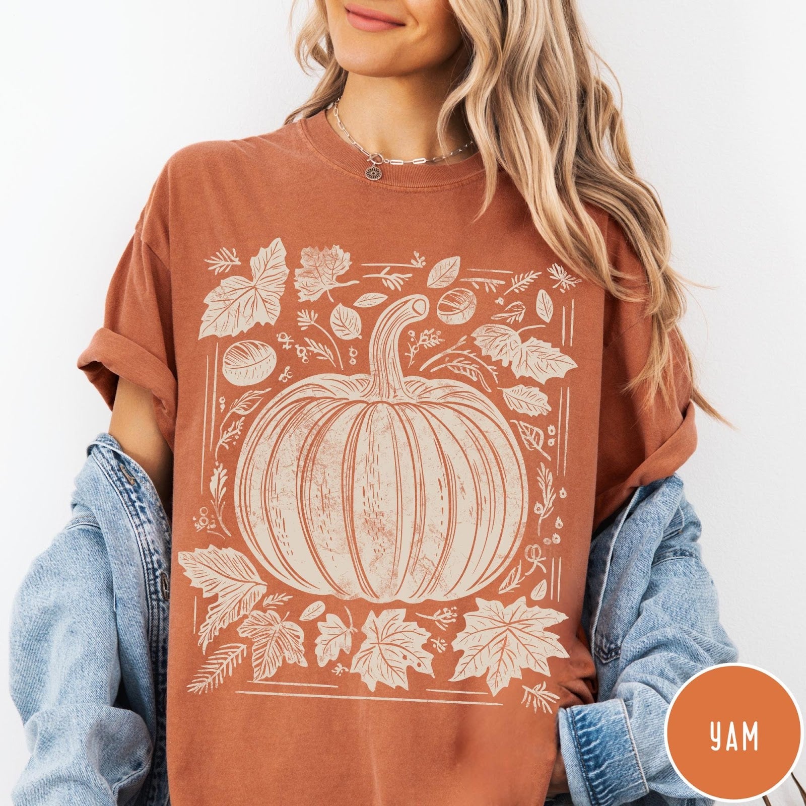 Comfort Colors tee in Yam featuring rustic pumpkin design with surrounding fall leaves and woodland elements