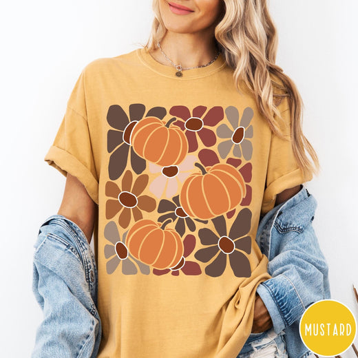 Comfort Colors tee in Mustard featuring boho floral style graphic with three orange pumpkins and brown flowers