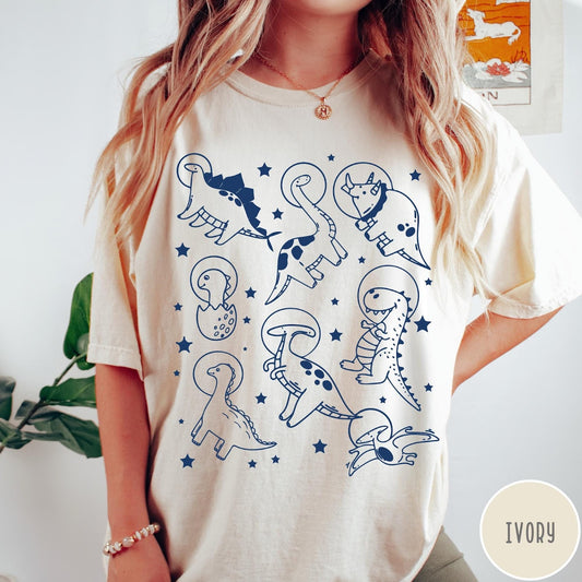 Comfort Colors tee in Ivory featuring line art graphic of various dinosaurs wearing astronaut helmets in space