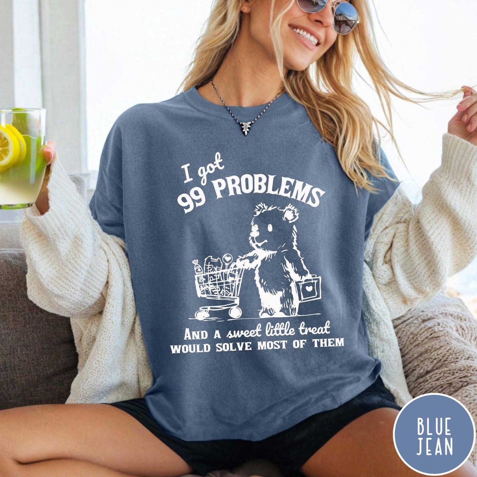 Comfort Colors tee in Blue Jean featuring graphic design of a bear pushing a shopping cart with treats
