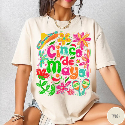 Comfort Colors tee in Ivory featuring festive Cinco de Mayo graphic with sombrero, maracas, and colorful flowers