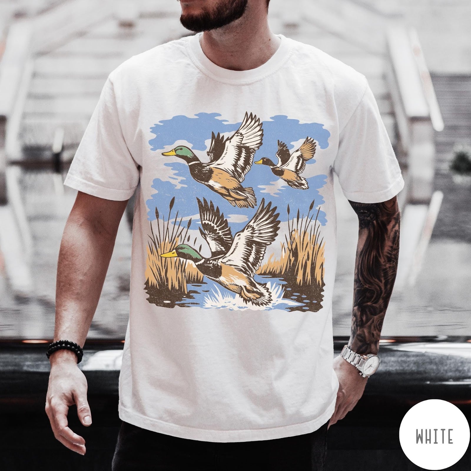 Comfort Colors tee in White featuring vintage style mallard ducks flying over a marshy pond graphic