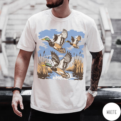Comfort Colors tee in White featuring vintage style mallard ducks flying over a marshy pond graphic