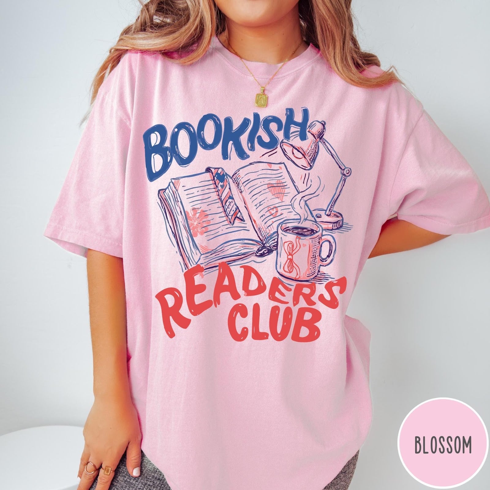 Comfort Colors tee in Blossom featuring bookish reading graphic with open book, lamp, and coffee mug