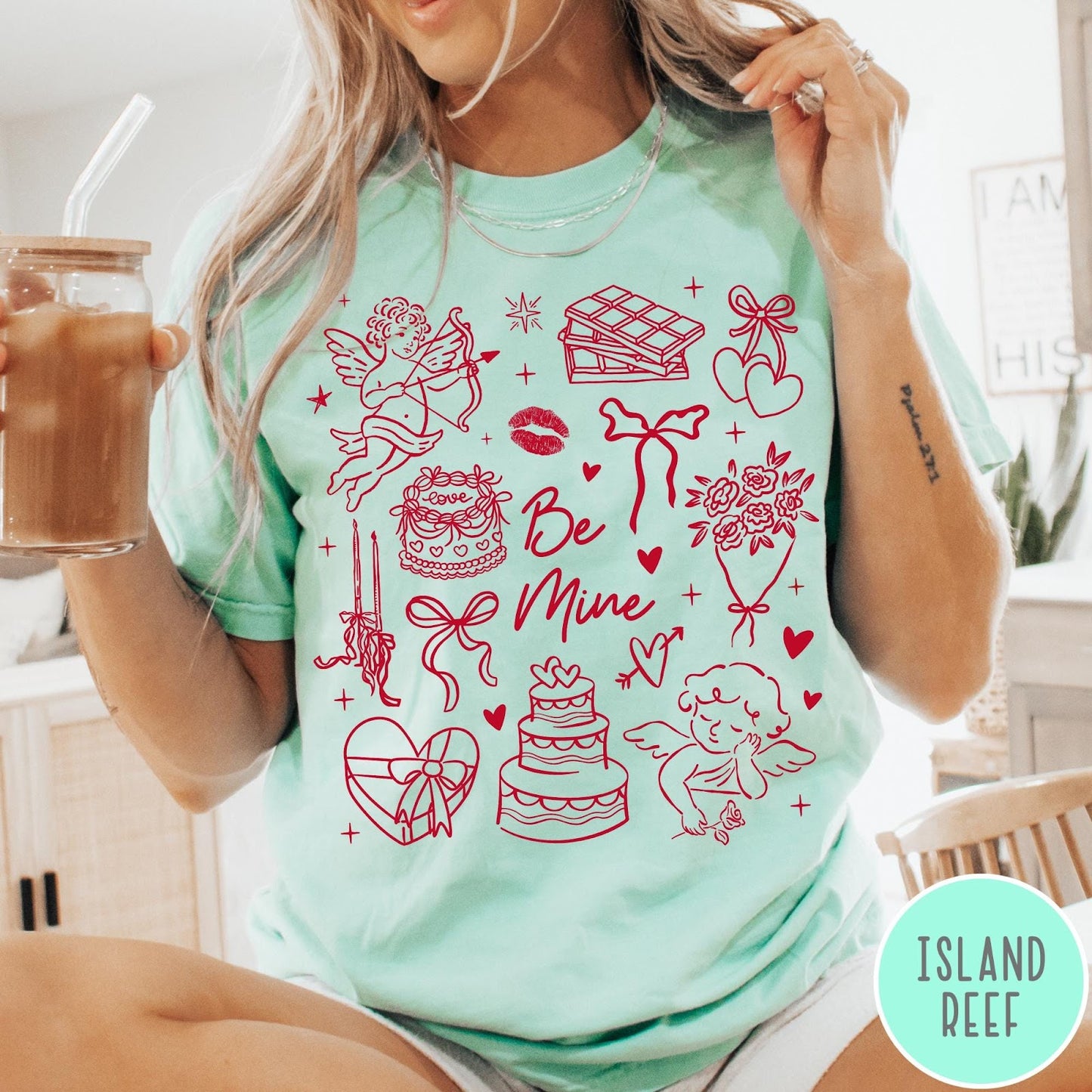 Comfort Colors tee in Island Reef featuring Valentine's Day collage graphic with cupid, cakes, and romantic symbols.