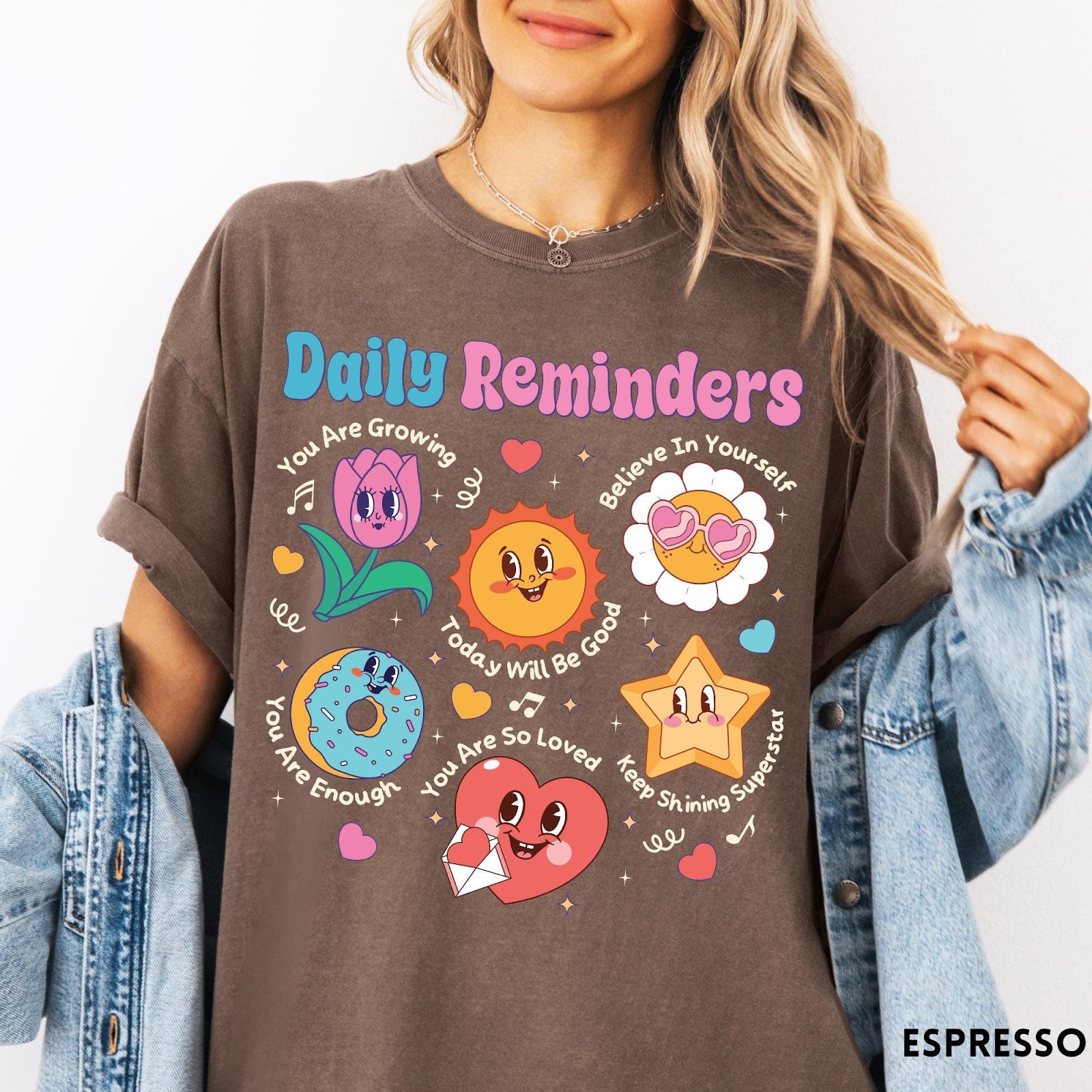 Comfort Colors tee in Espresso featuring retro mascot design with daily affirmations and colorful cartoon characters