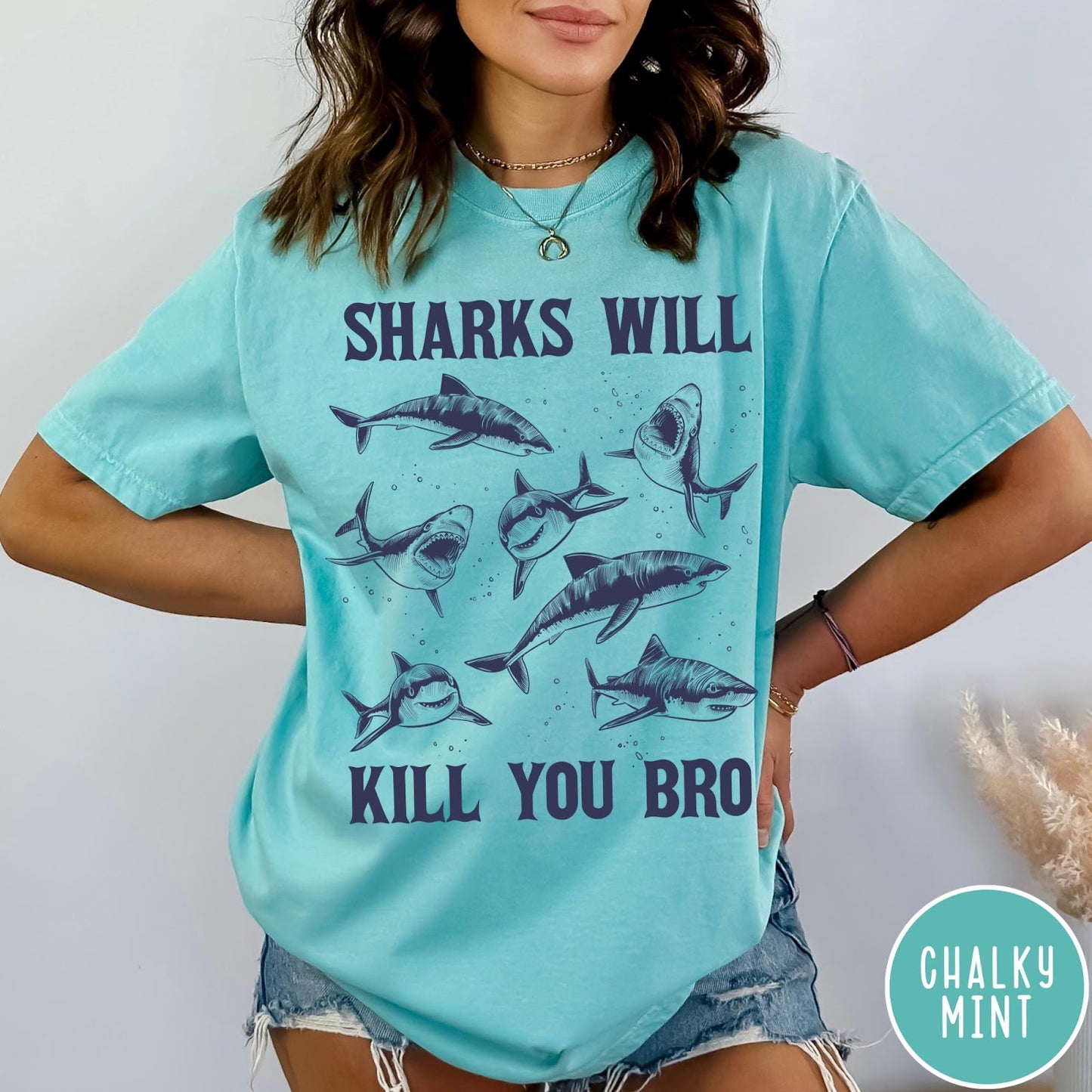 Comfort Colors tee in Chalky Mint featuring illustrative style graphic of multiple sharks and text Sharks Will Kill You