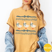 Comfort Colors tee in Mustard featuring vintage style graphic with three geese wearing blue ribbons and floral borders