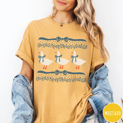 Comfort Colors tee in Mustard featuring vintage style graphic with three geese wearing blue ribbons and floral borders