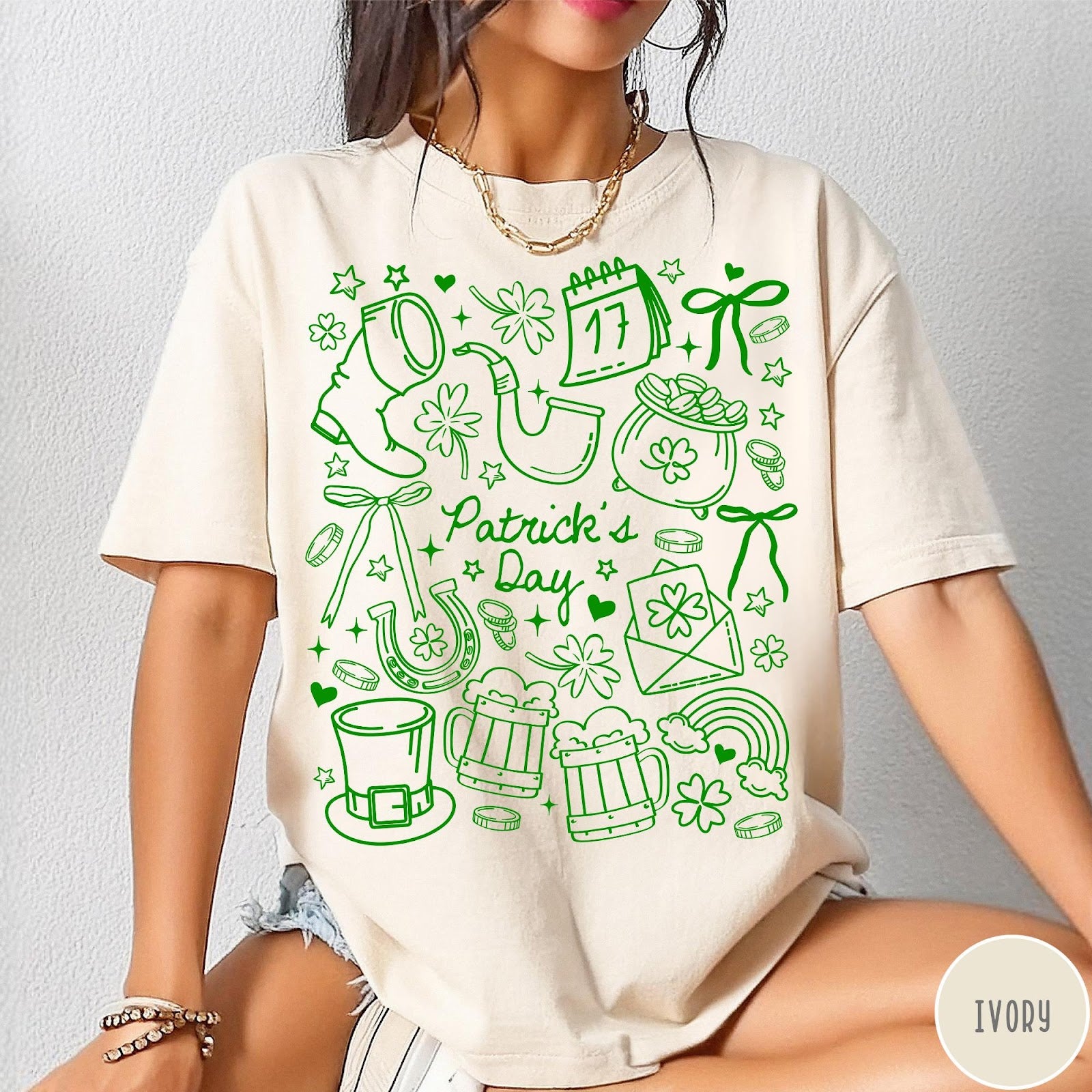 Comfort Colors tee in Ivory featuring line art style St. Patrick's Day icons including shamrocks and leprechaun hat