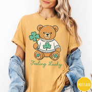 Comfort Colors tee in Mustard featuring cute teddy bear graphic wearing a sweater with shamrocks