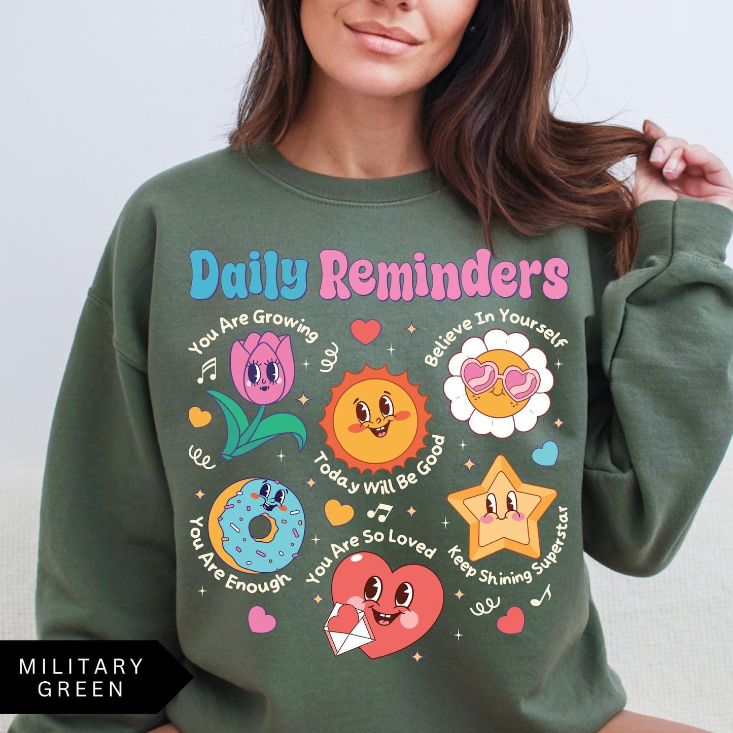 Comfort Colors tee in Military Green featuring retro mascot design with daily affirmations and cute cartoon characters
