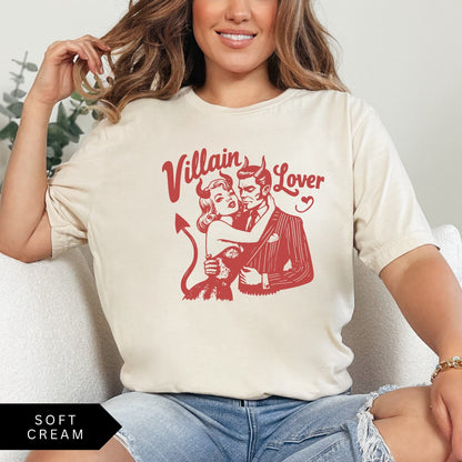 Comfort Colors tee in Soft Cream featuring vintage style graphic of a devilish couple embracing with text Villain Lover