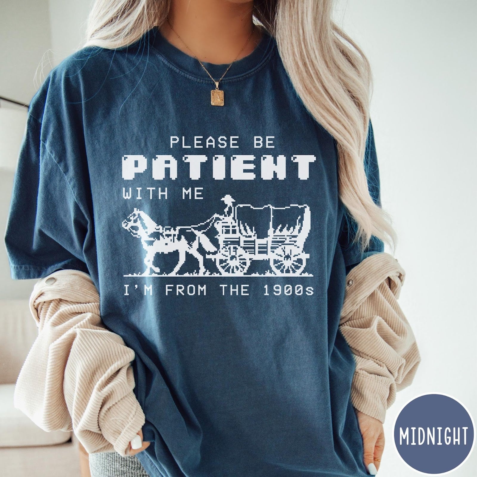 Comfort Colors tee in Midnight featuring pixel art style graphic of a horse drawn covered wagon