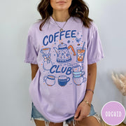 Comfort Colors tee in Orchid featuring retro graphic design with coffee pots, mugs, and iced coffee