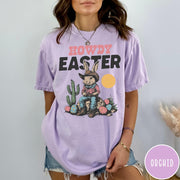 Comfort Colors tee in Orchid featuring western design style cowboy bunny sitting on a rock with cactus