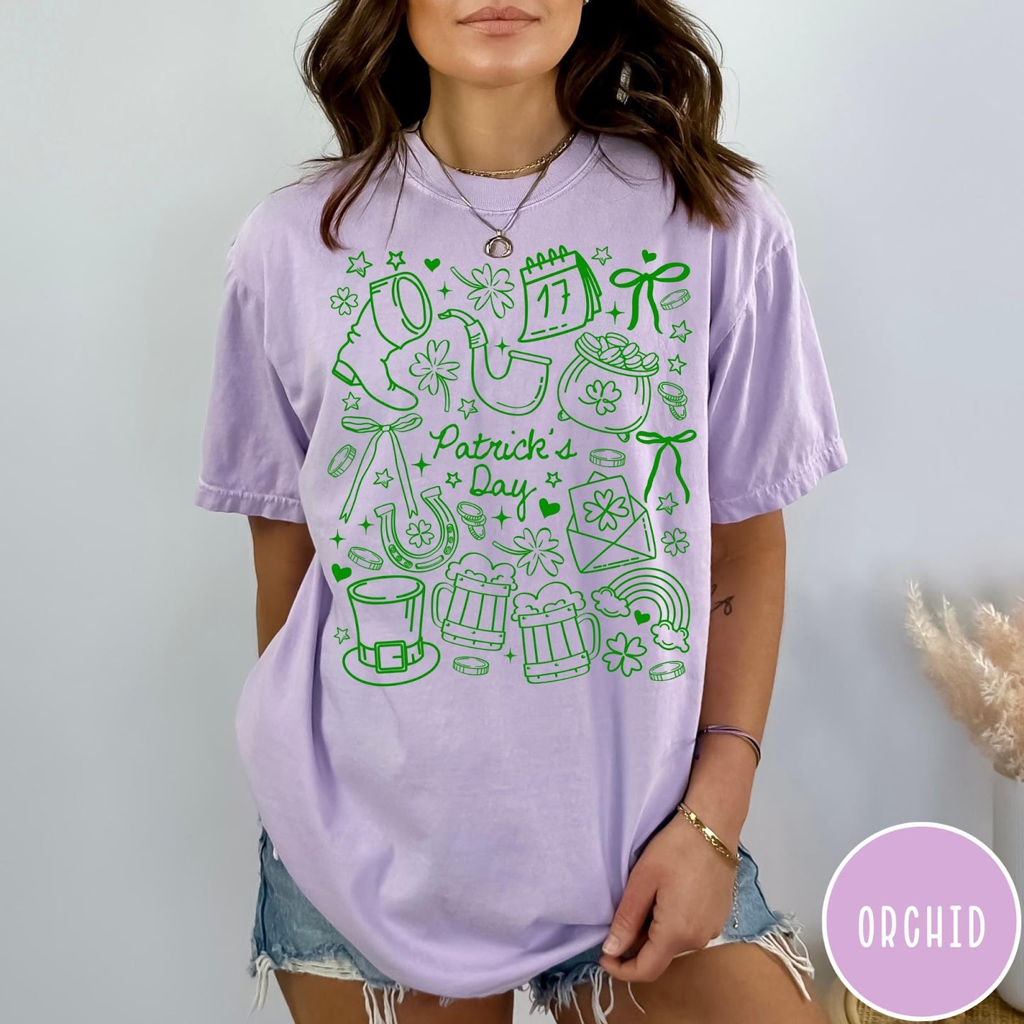 Comfort Colors tee in Orchid featuring line art style St. Patrick's Day icons and symbols