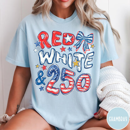 Comfort Colors tee in Chambray featuring patriotic 250th anniversary graphic with red white and blue stars and bow