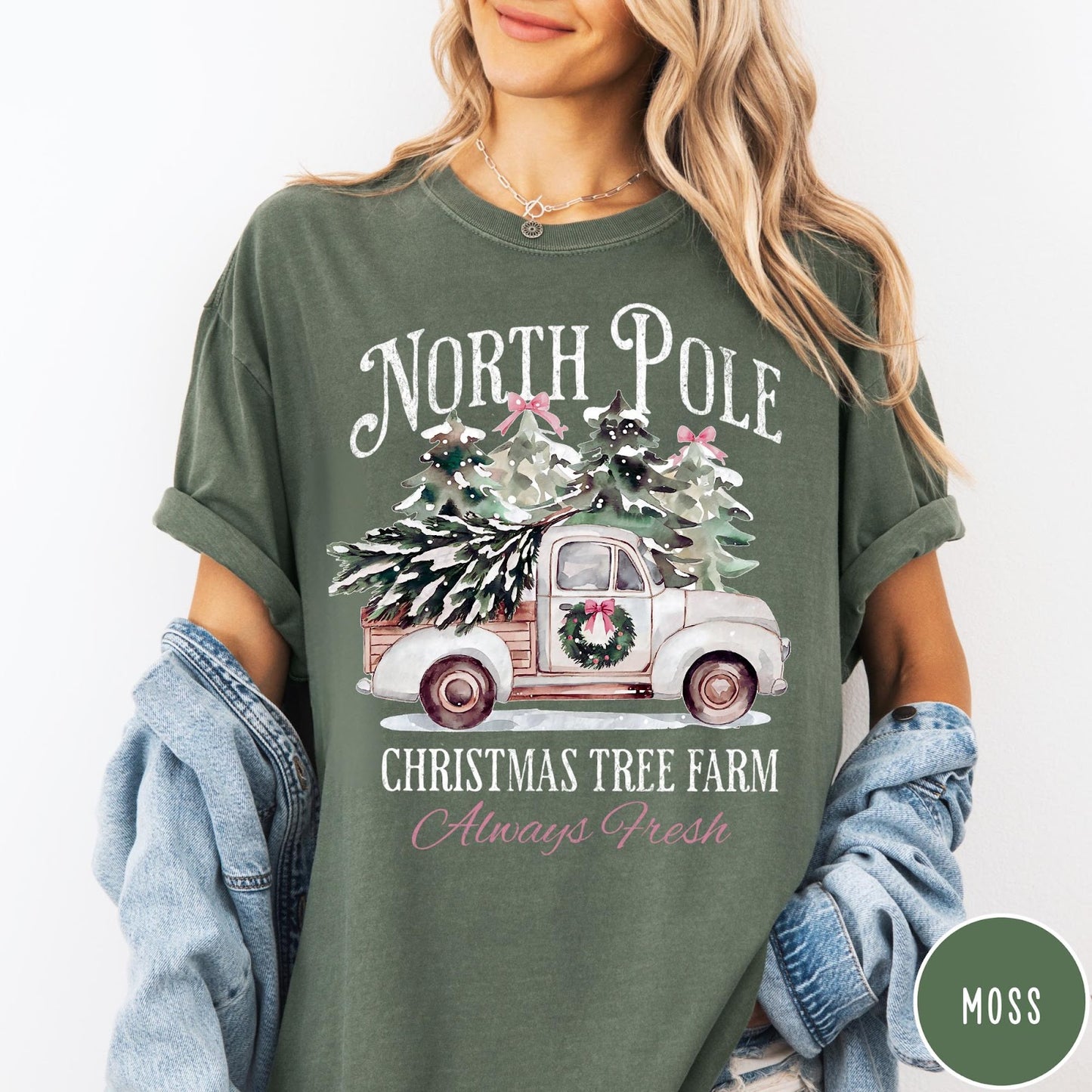 Comfort Colors tee in Moss featuring vintage style Christmas tree farm truck graphic with snowy pine trees