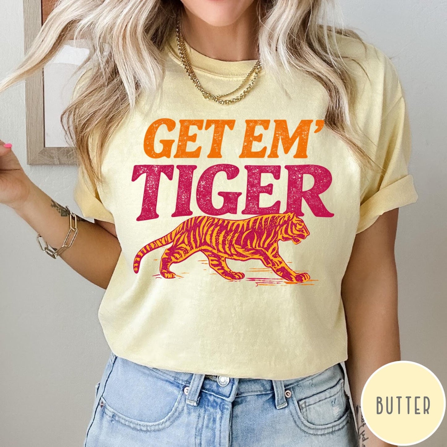 Comfort Colors tee in Butter featuring vintage style graphic with orange text and a walking tiger illustration