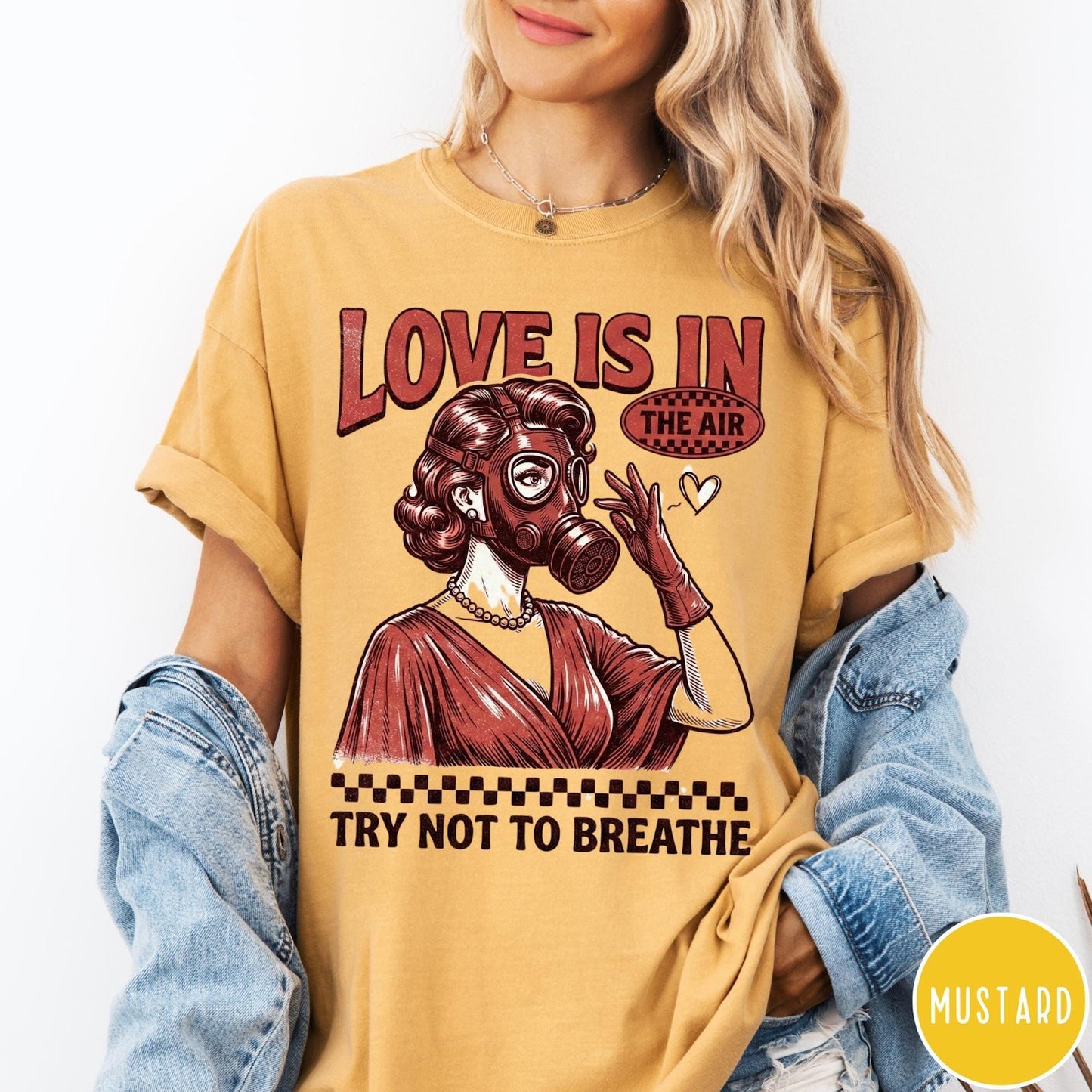 Comfort Colors tee in Mustard featuring retro graphic design of a woman wearing a gas mask