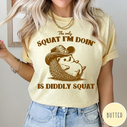 Comfort Colors tee in Butter featuring cute graphic style illustration of a hedgehog wearing a cowboy hat