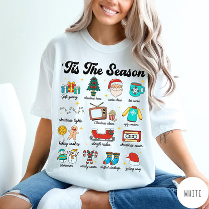 Comfort Colors tee in White featuring holiday icons graphic with Christmas trees, Santa, and festive seasonal imagery