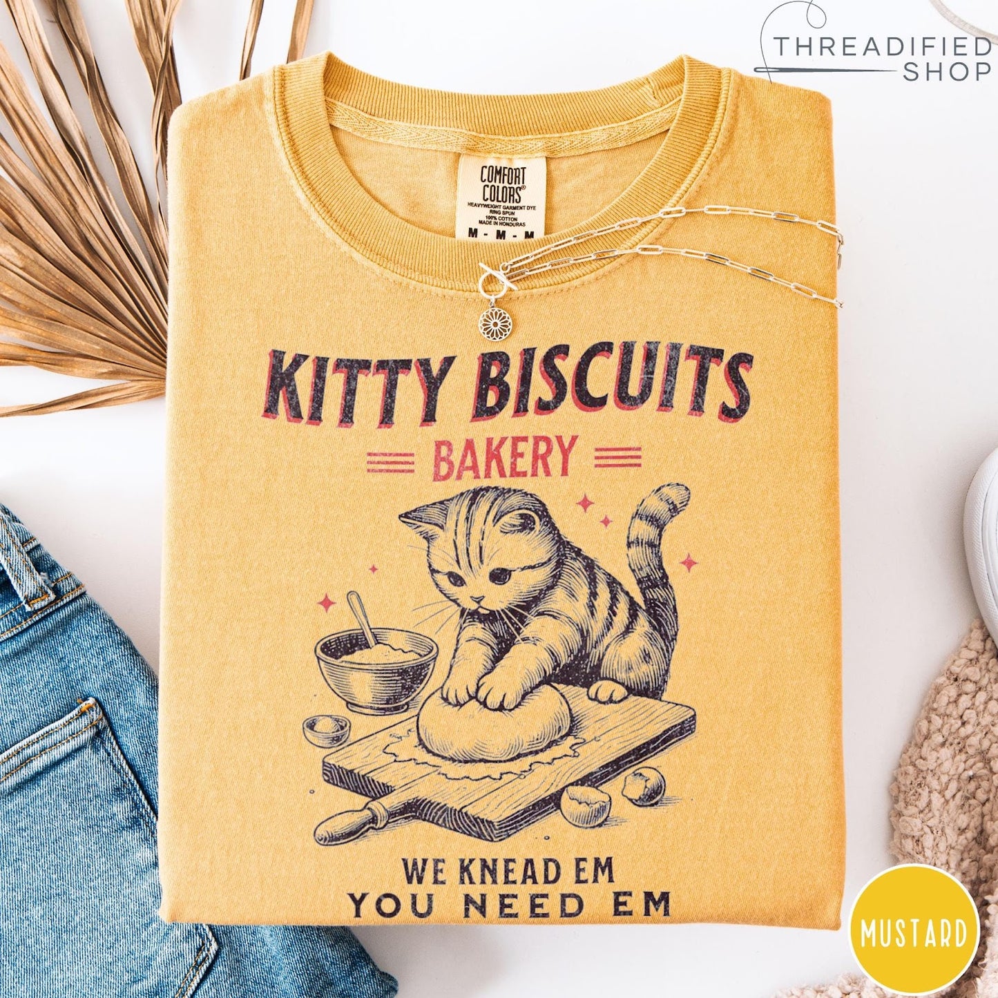 Comfort Colors tee in Mustard featuring vintage style graphic of a cute cat kneading dough for biscuits