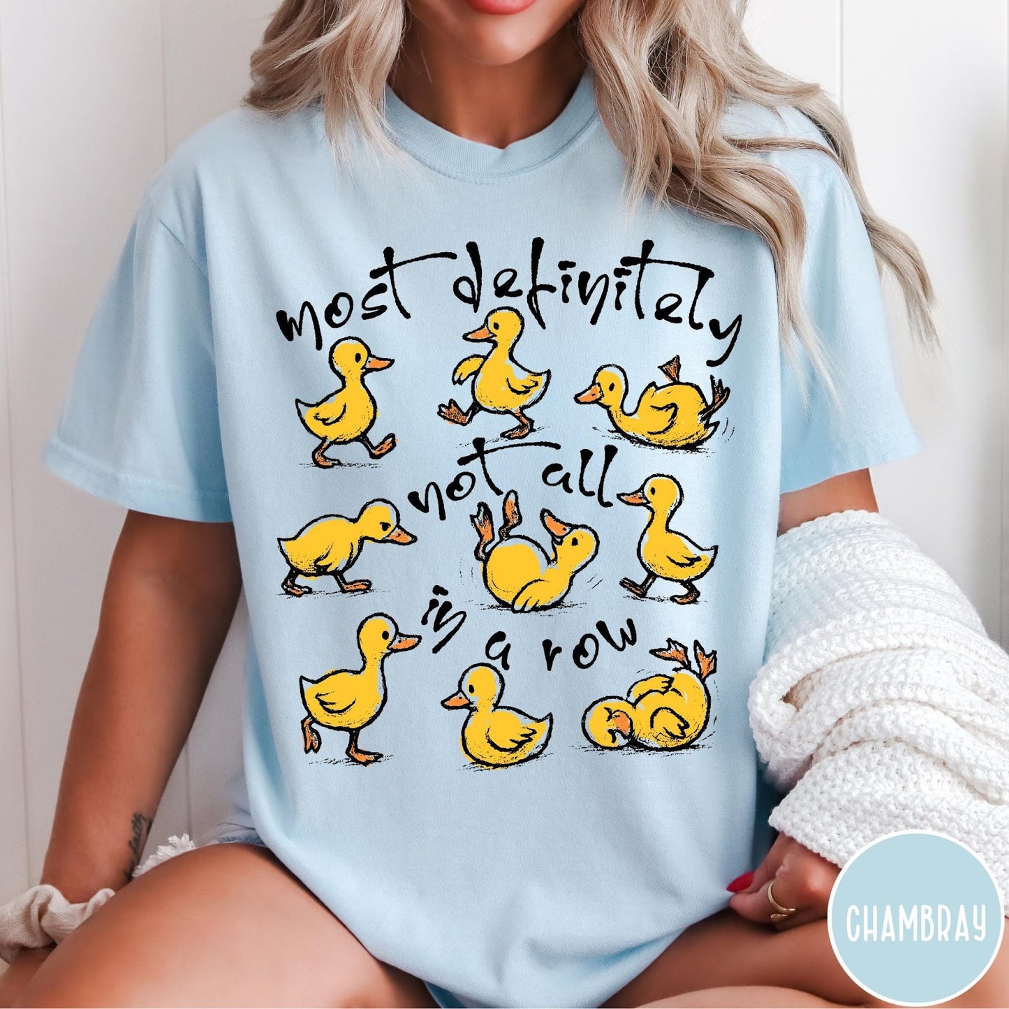 Comfort Colors tee in Chambray featuring screen print style graphic of nine yellow ducks in various poses