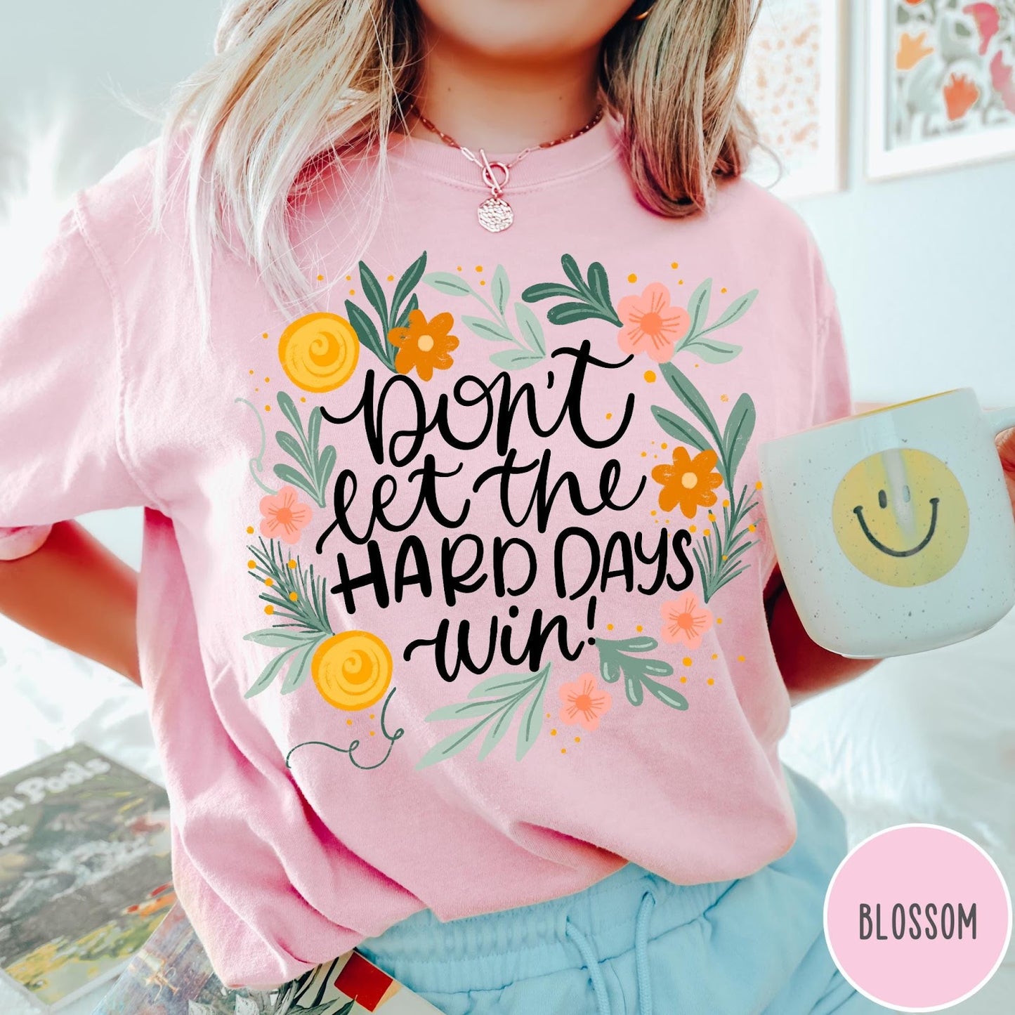Comfort Colors tee in Blossom featuring floral mental health encouragement graphic with the text Don't Let The Hard Days Win