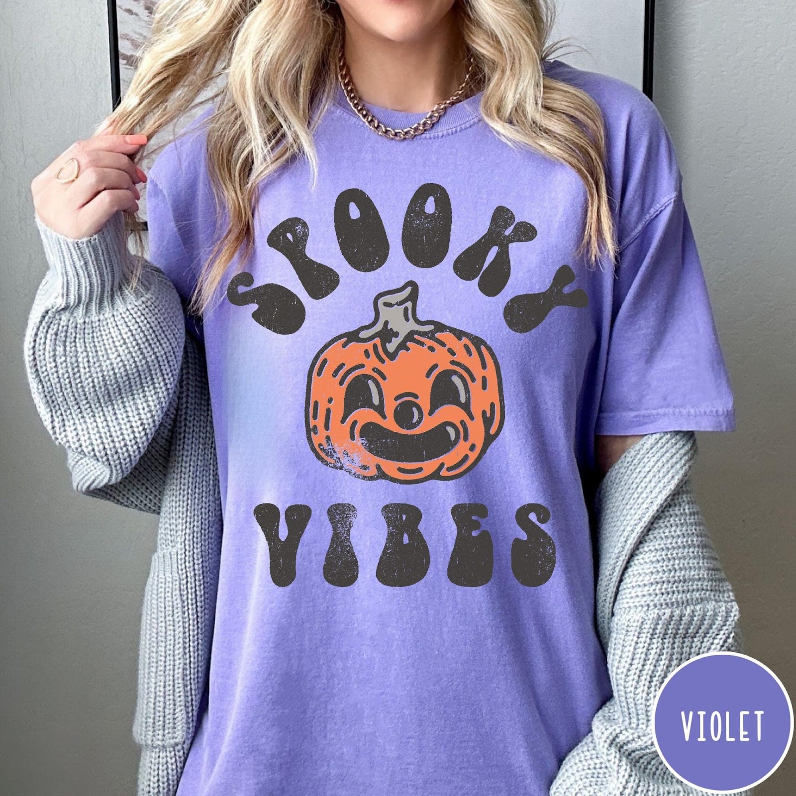 Comfort Colors tee in Violet featuring retro style graphic with a smiling pumpkin and Spooky Vibes text