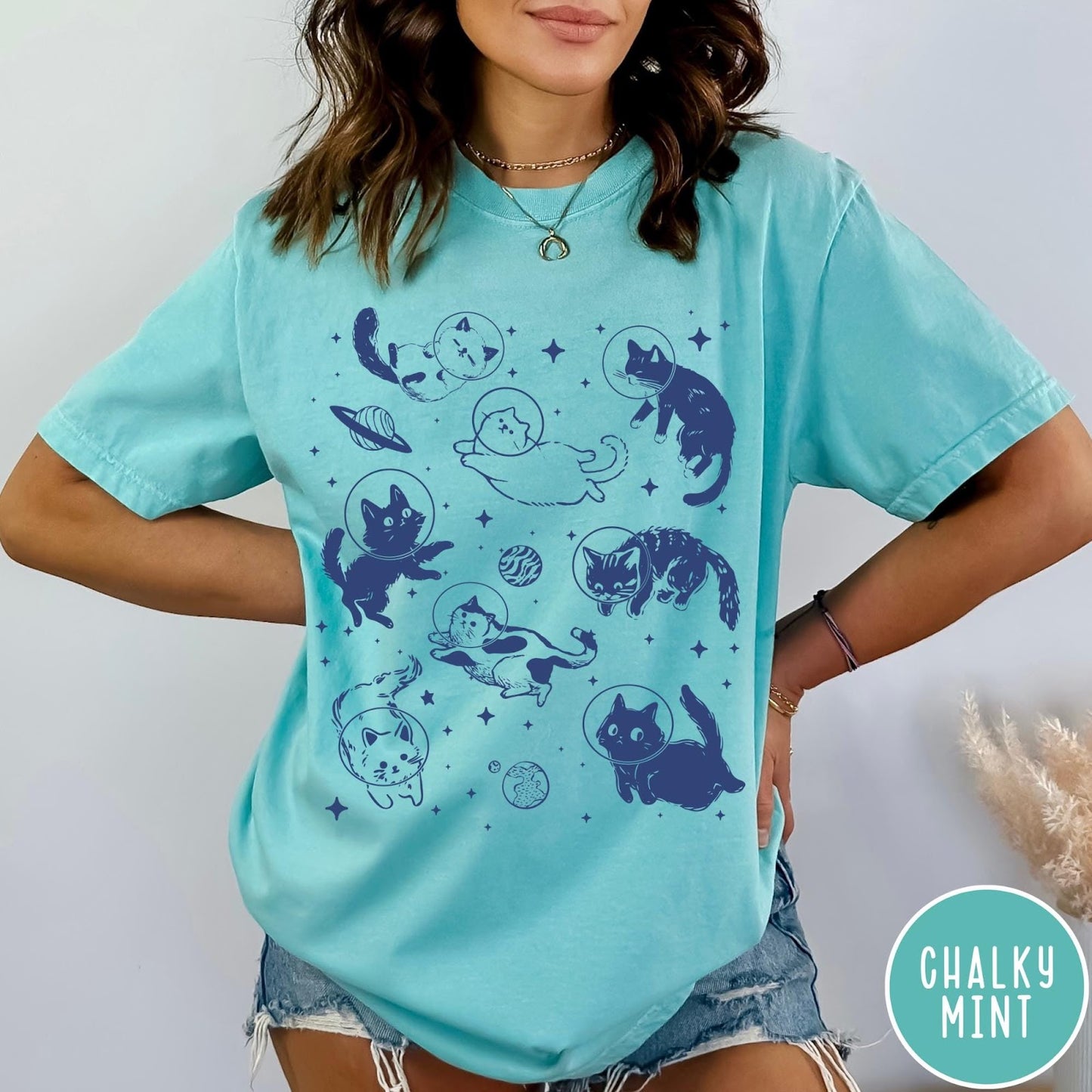 Comfort Colors tee in Chalky Mint featuring whimsical space style graphic with multiple cats floating in space helmets