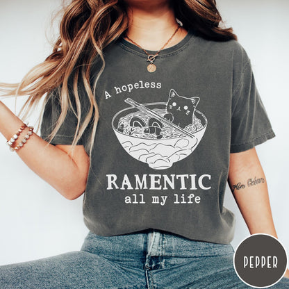 Comfort Colors tee in Pepper featuring line art graphic of a cute cat inside a ramen bowl