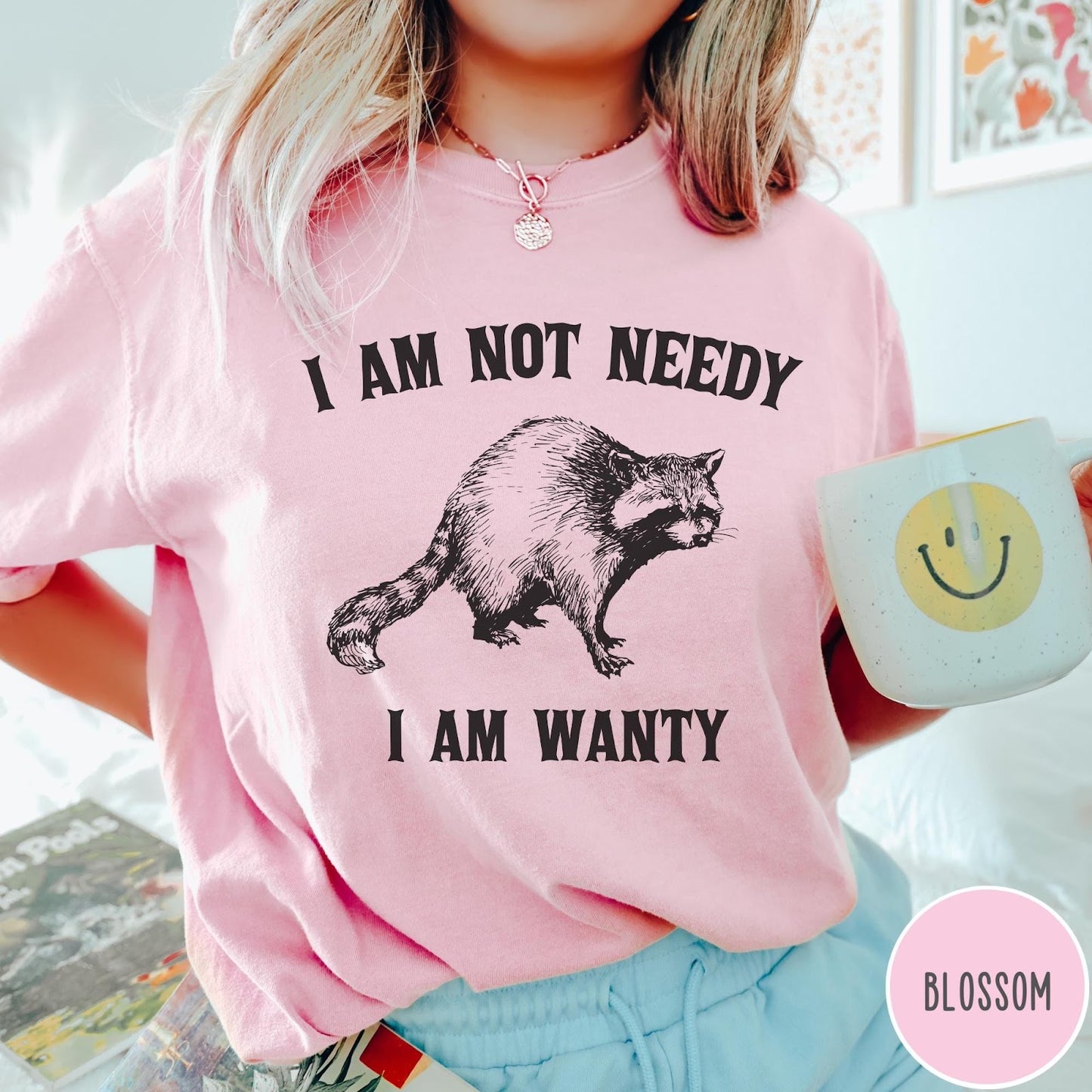 Comfort Colors tee in Blossom featuring vintage style graphic of a raccoon with text I Am Not Needy