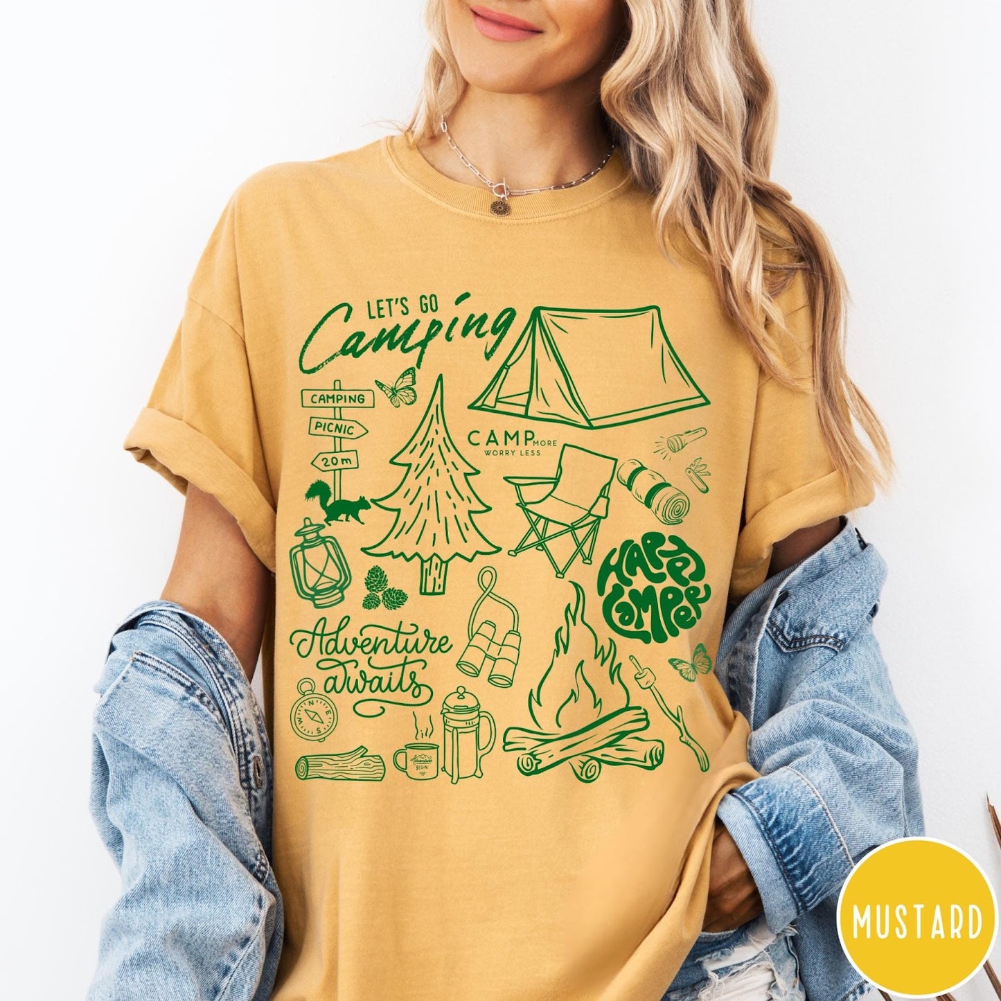 Comfort Colors tee in Mustard featuring retro camping adventure collage graphic with tent, campfire, and outdoor icons